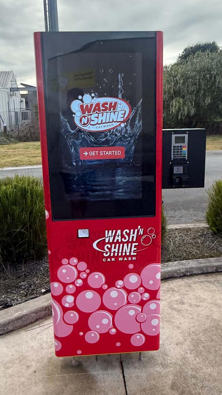 The Wash N Shine payment kiosk at the entrance to the automatic wash